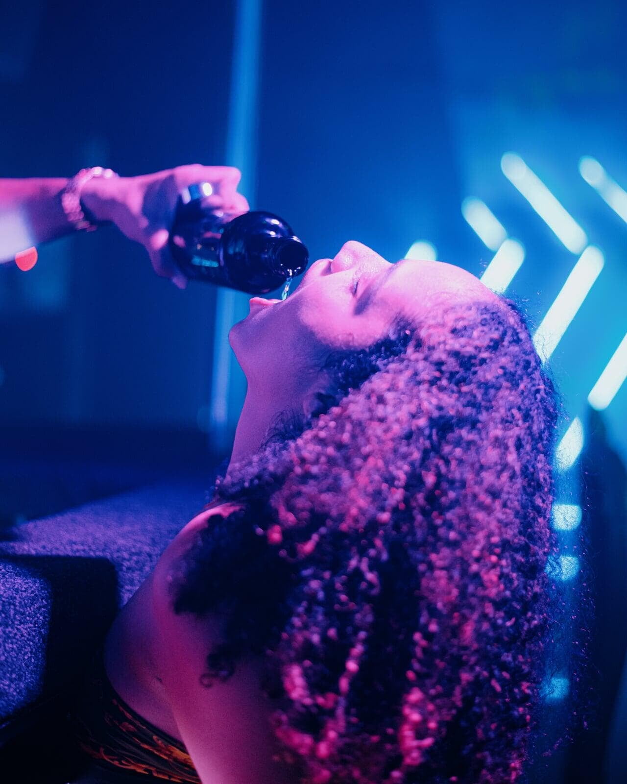 Image of party goer being given a beverage